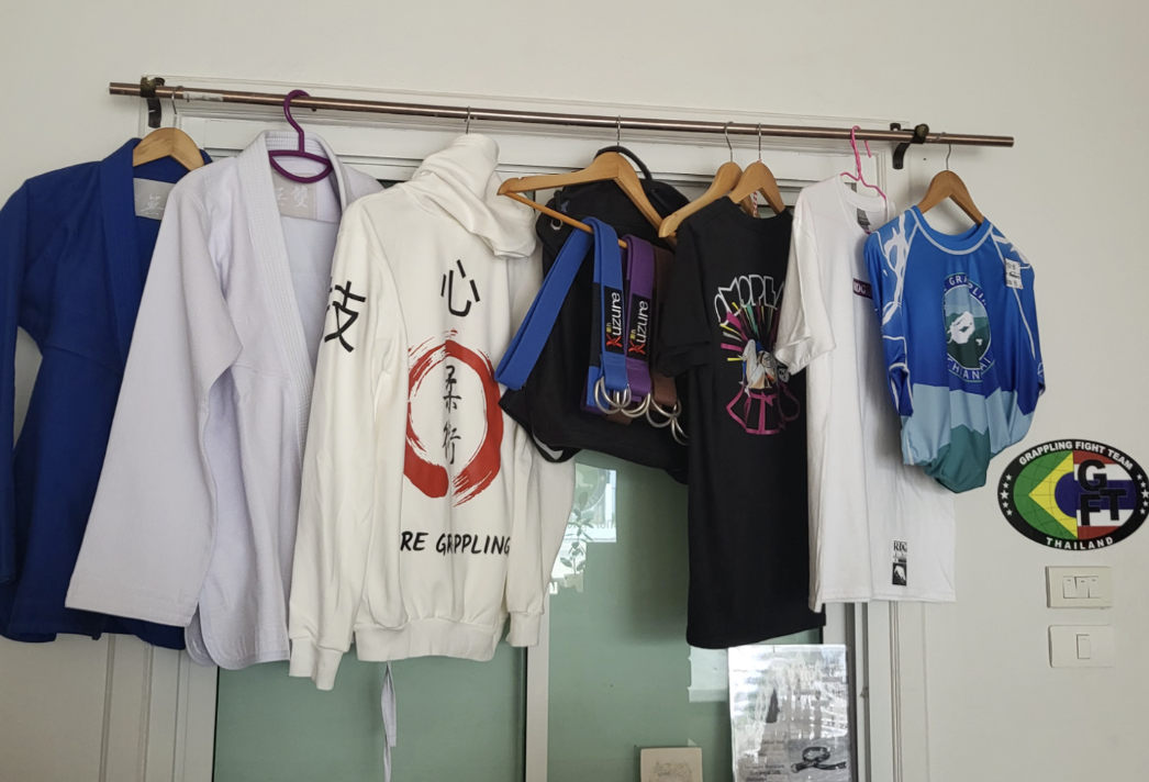 Gis and clothes hanging on the gym wall